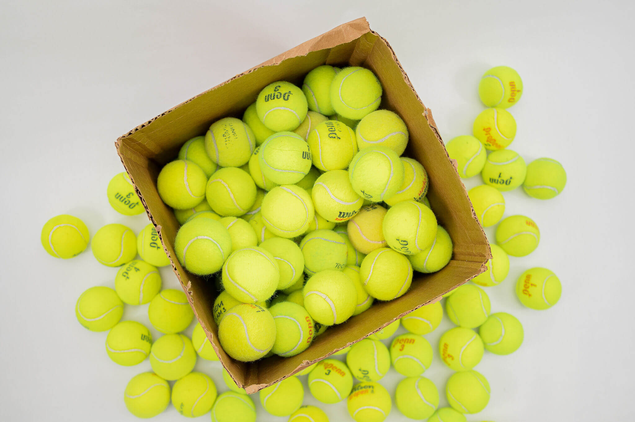 Gently Used Tennis Balls in a Cardboard Box